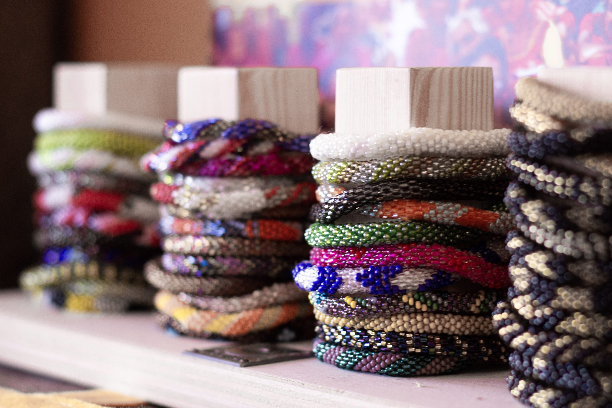 Stacks of handmade bracelets made by women in Nepal.