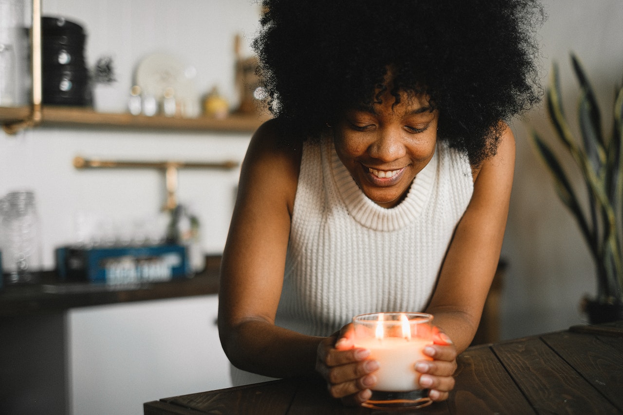 Happy woman holding a candle